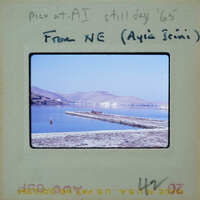 Picture of a scenic lake with mountains in the background, taken on a sunny day.