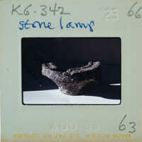 A photograph of a stone lamp with a vintage Polaroid border.