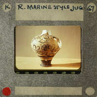 Vase with intricate design on wooden table.