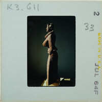 Detail of almost complete terracotta figurine from the side minus right arm.