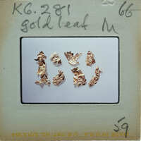 The image shows a collection of gold leaf samples on a white surface, with a label that reads "Gold Leaf M" and includes the number "6281".