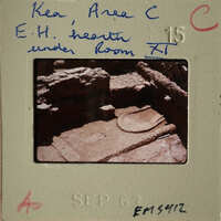 Ancient ruins with visible stone structures and markings, possibly from an archaeological site.