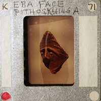 Picture of an old-fashioned movie clapperboard with a photo of a sculpture on it.