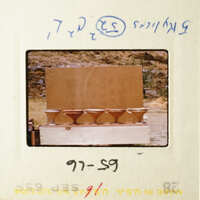 The image shows three brown bowls on a table, with a cardboard box behind them.