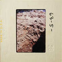 A photograph of an outdoor scene with rocks and dirt, possibly from a geological study or fieldwork.