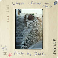 Old stone stairs with a wall made of stacked stones.