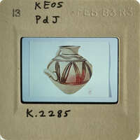 The image shows an antique vase with intricate designs, photographed against a white background.