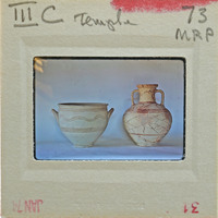 Two reassembled pots, one bowl, one amphora with similar red striped design in profile.