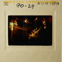 This is an old photo of a person holding a camera.