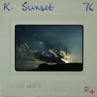 A vintage sunset photo with a white border and handwritten notes on the back.