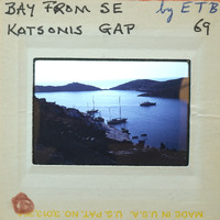 Photo of a harbor with boats and hills.