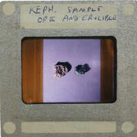 Two small rocks on a purple background with white writing.