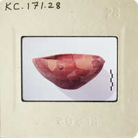 Ancient pottery with visible cracks and missing pieces, photographed on a white background.