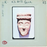 Terracotta face of figurine.