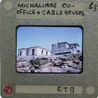 A slide of modern buildings on a stone hilltop.