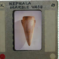 Slideof a marble vase in profile on white background.