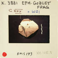 A photograph of an ancient artifact, possibly a stone carving with markings and symbols.