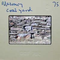 Old photograph of a stone wall with grass, dated October 1976.