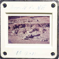 This is an old photograph showing excavated ruins with visible stone structures and foundations.