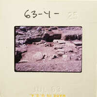 Ancient ruins with scattered rocks and dirt on a film strip.