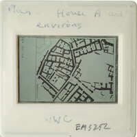 Black and white map of a city with handwritten notes on a transparent surface.