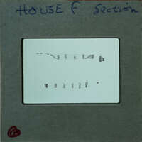 A close-up image of a film strip with visible sprocket holes and perforations.