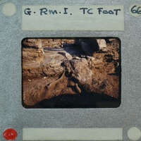 A photograph of a rock formation with a handwritten label on the border.