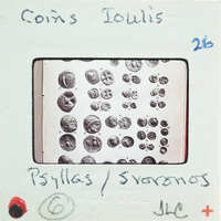 Image of a coin collection with labels and numbers on a card.