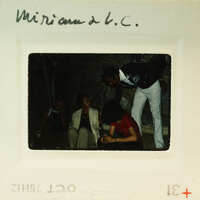 A vintage photograph of a group of people, with handwritten notes on the border.