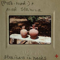 Two clay vases on a wooden surface.