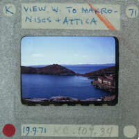 A vintage film strip with a photograph of a scenic coastal landscape.