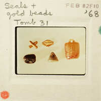 Collection of beads and jewelry items displayed on a white surface.