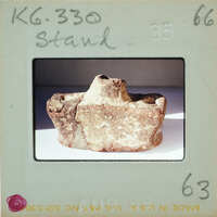 An old, cracked object resembling a fossil or artifact on display.