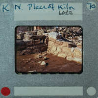 A photograph of an old stone structure with a film strip border and writing on it.