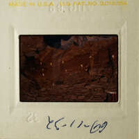 The slide depicts a cave-like structure with rock formations and possibly some water or light reflections.