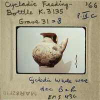 Ancient ceramic vase with label indicating its origin and type.