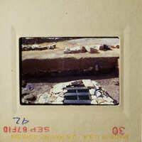 The photo shows an outdoor scene with a stone structure and some rocks in the foreground.