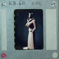 Detail of almost complete terracotta figurine from the side minus right arm.