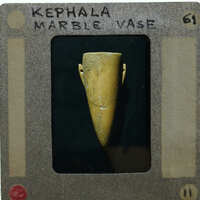 Marble vase in profile with black background.