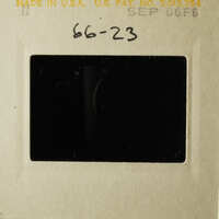 A vintage photo with a handwritten note on it, placed in a lightbox.