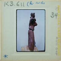 Detail of almost complete terracotta figurine from the side minus right arm.