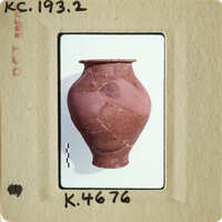 Ancient clay pot with visible cracks and imperfections, displayed against white background.