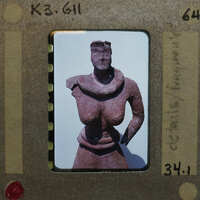 Detail of terracotta figurine K3.611 from front showing torso and face.