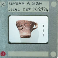 Ancient artifact with markings on a display card.