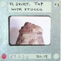 Terracotta figurine detail showing top of skirt.