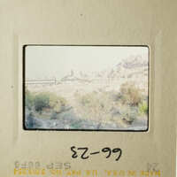 This is an old photograph depicting a scenic landscape with a mountain and buildings, possibly taken during a trip.