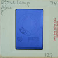 Image of a stone lamp with a blue outline and notes on its features, including an eye-like detail and a handle.