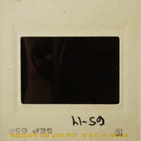 A photograph showing an empty film strip frame with handwritten notes.