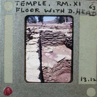 Photo of an excavation site with stone ruins, dated March 12, 1963.