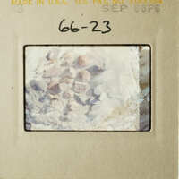 The image shows a vintage photograph with a label and a barcode, depicting a rocky landscape with a close-up of rocks and stones.